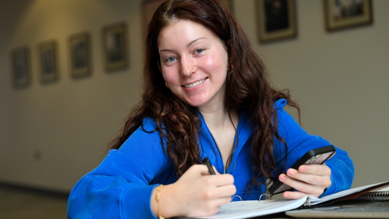 A student studying in her journal. 