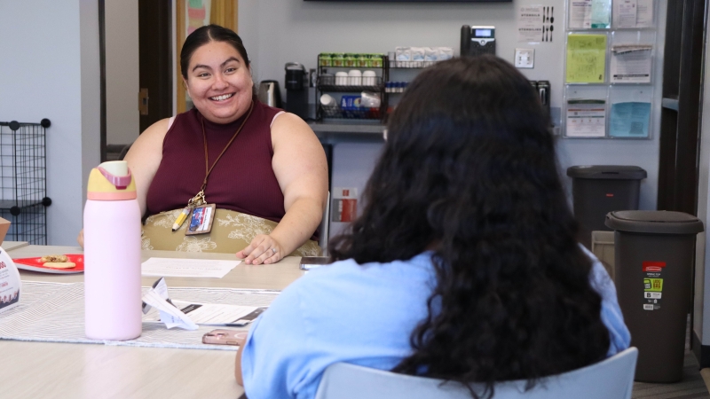 Melany Villagomez and a student having a snacks and chats session in the EDI center